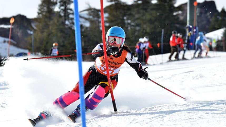 student athlete aly kennedy skiing down a track