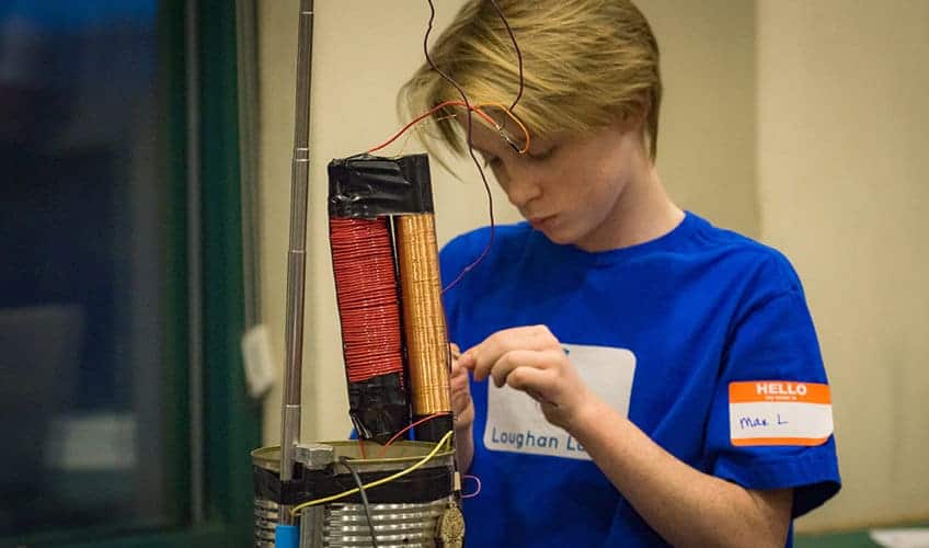 student working with electrical coils