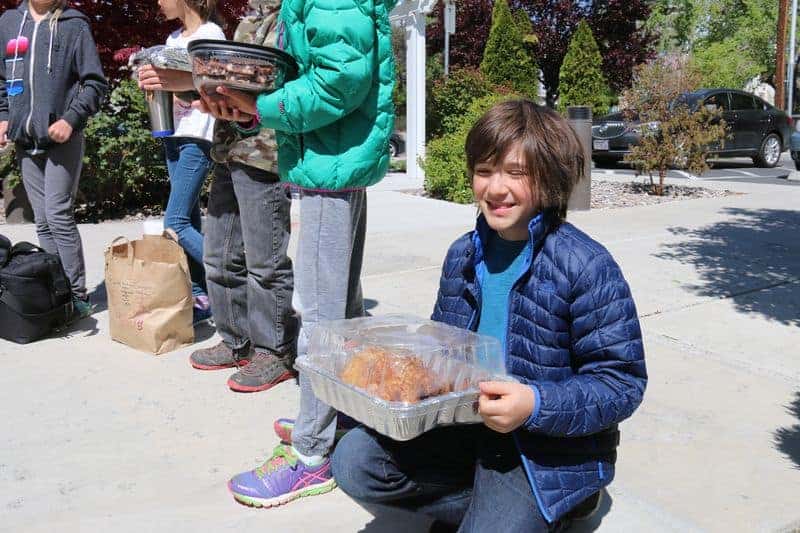 5th grader holding a boxed turkey