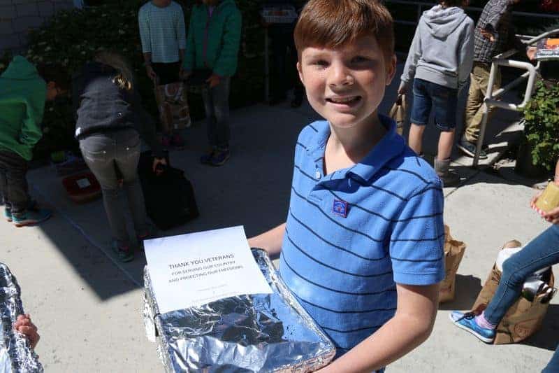 5th grader holding a tray of food