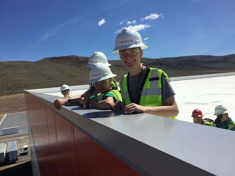 students on top of the tesla building