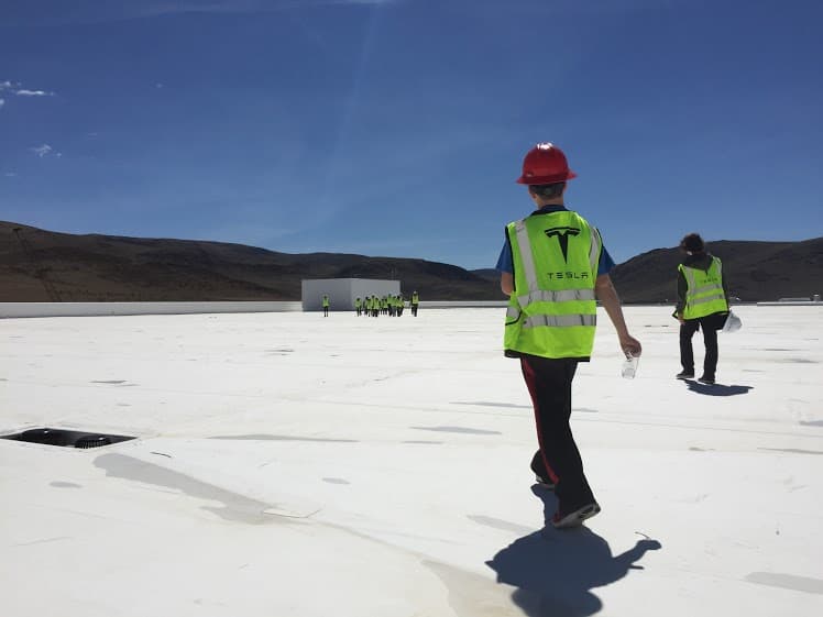 students on top of the tesla building