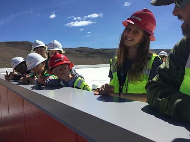 students on top of the tesla building