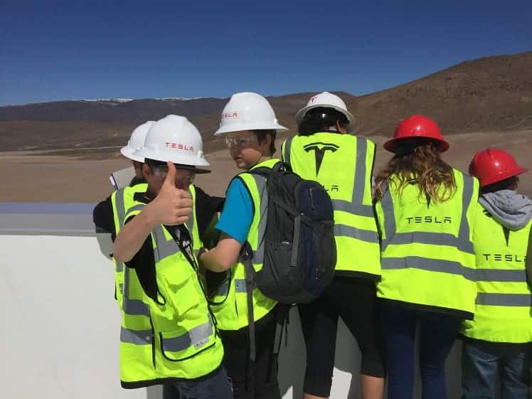 students on top of the tesla building