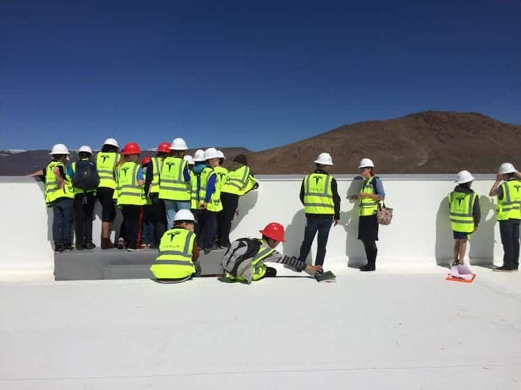 students on top of the tesla building