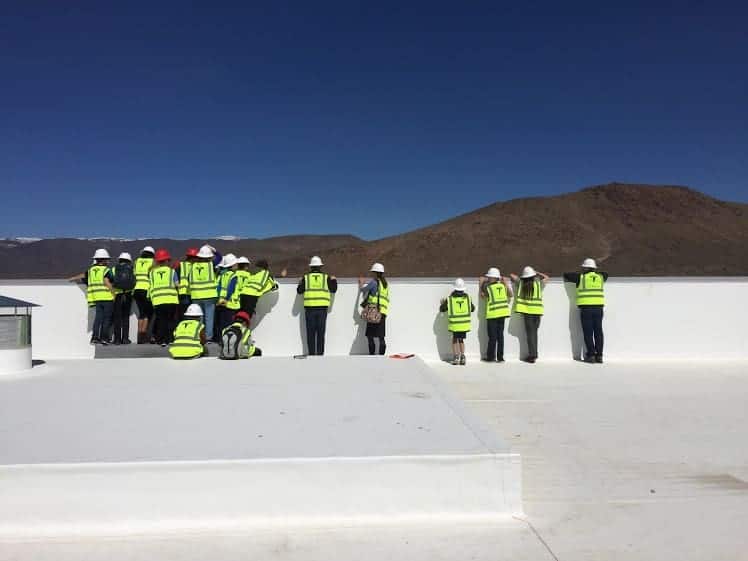 students on top of the tesla building