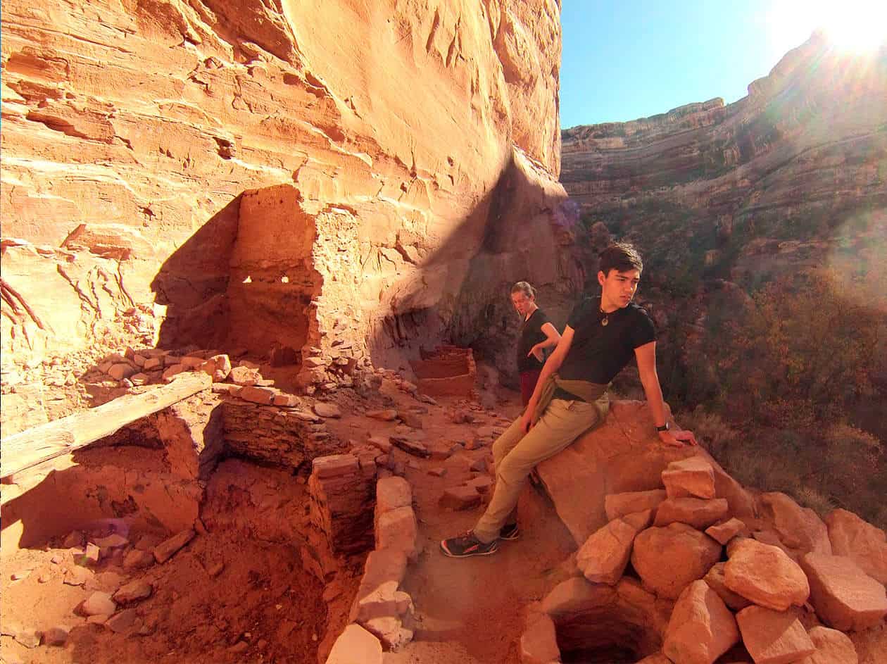 students sitting on rocks next to a cliff