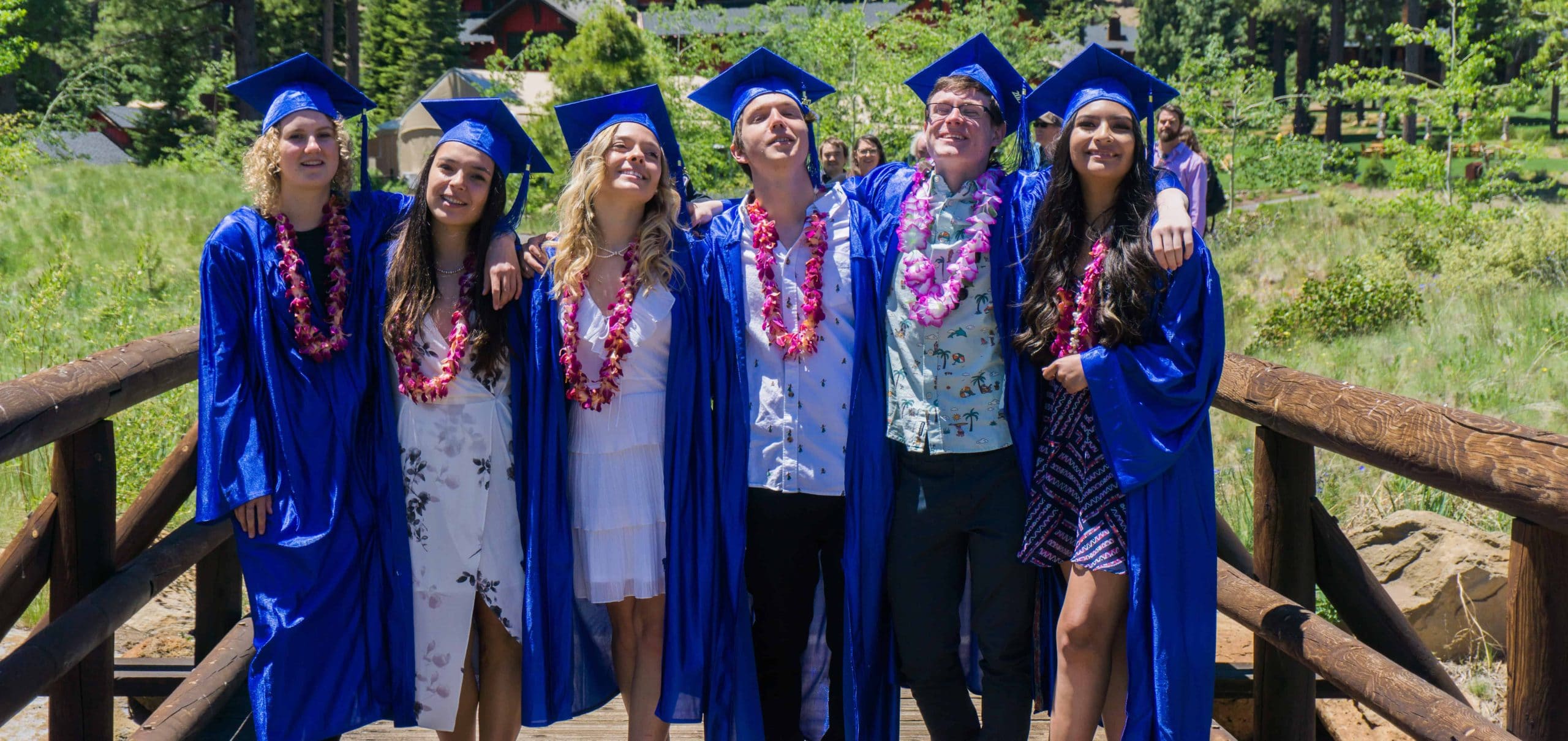 graduates wearing their caps, gowns, and leis