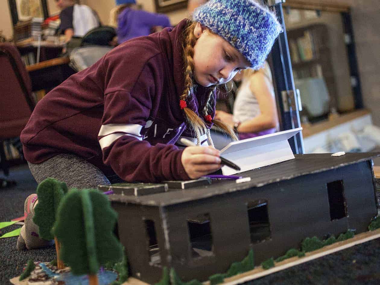 student working on a diorama