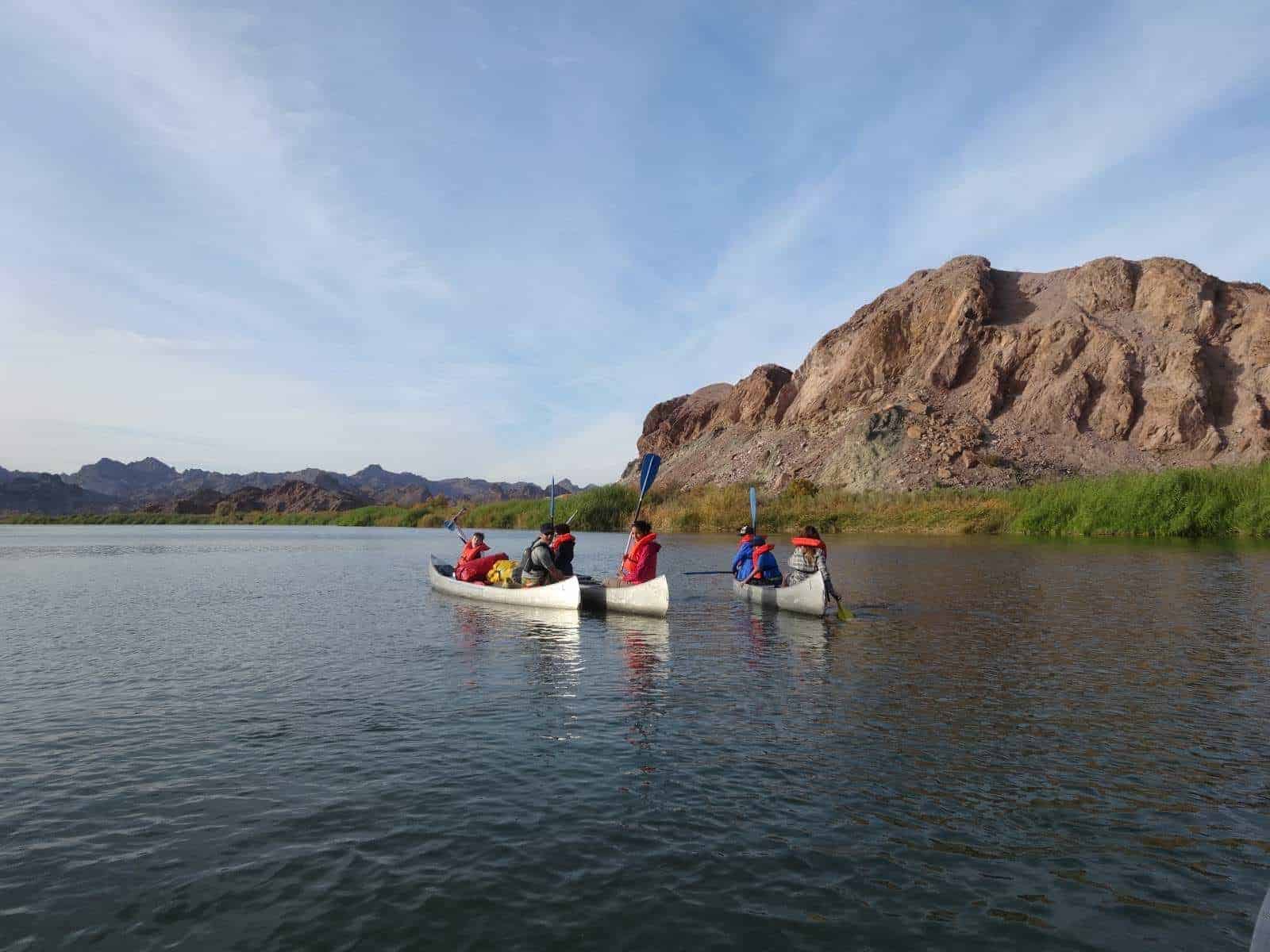 students canoe down the colorado river