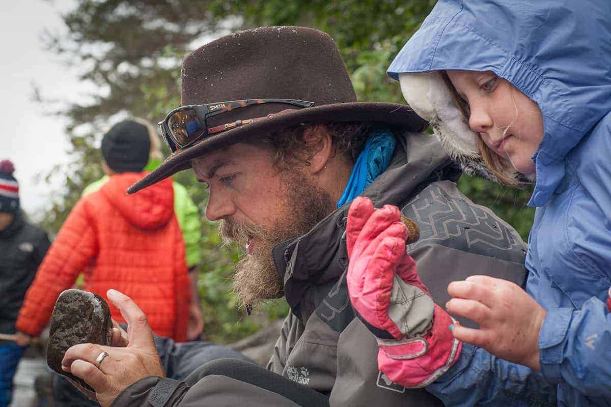 student and teacher inspecting rocks