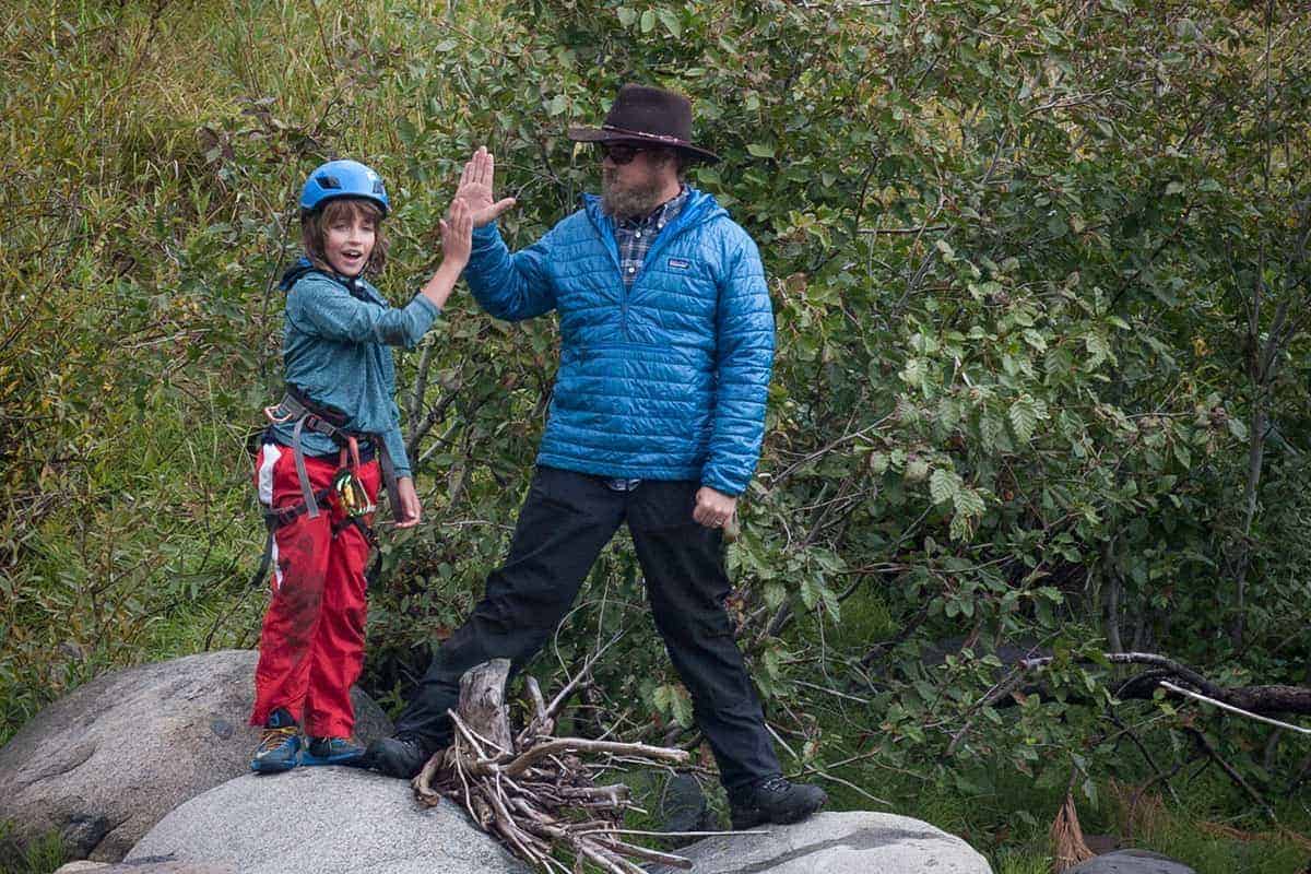 student and teacher high-fiving