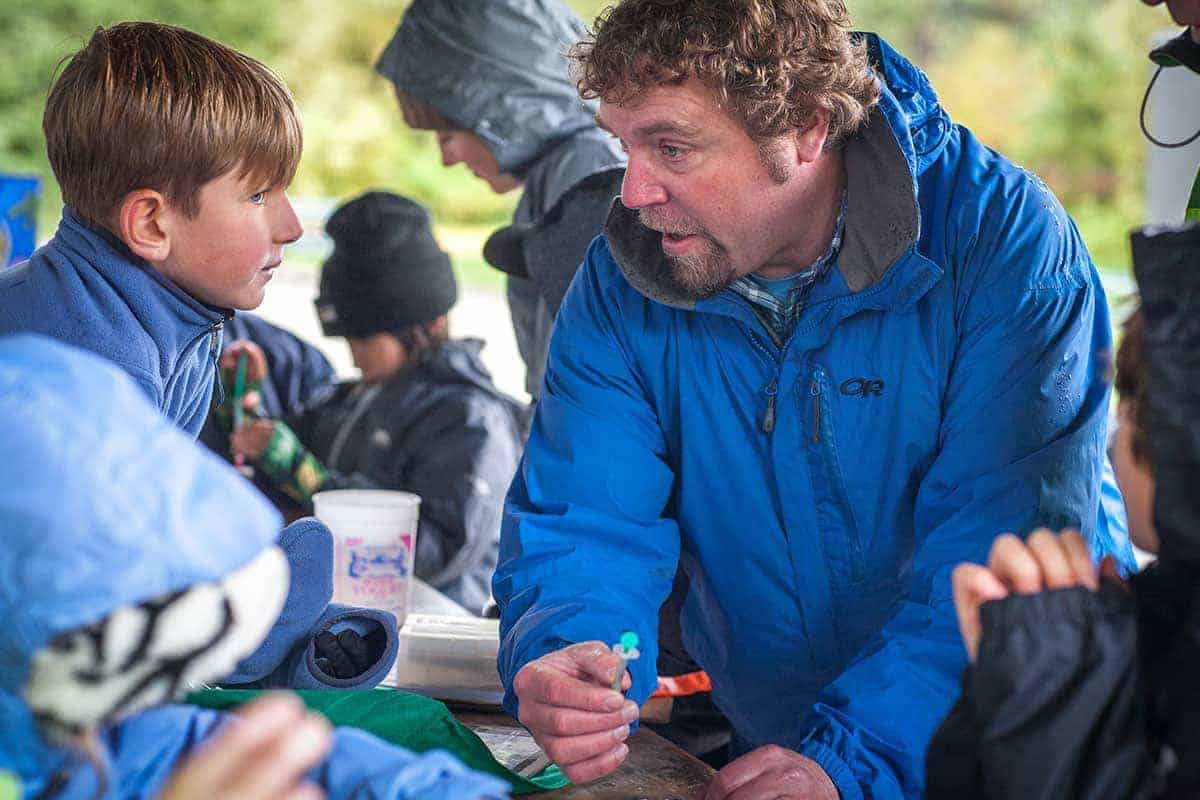 teacher holding water sample talking to students