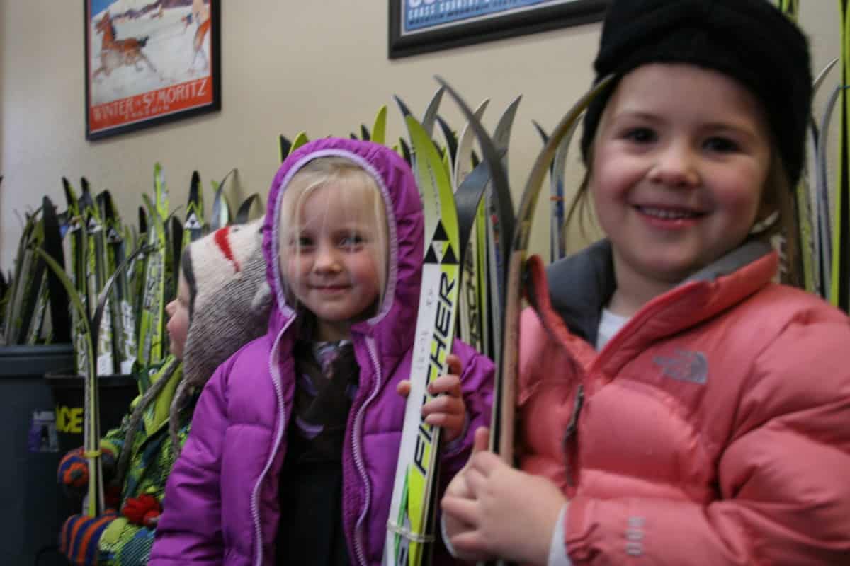 pre-k students holding skis