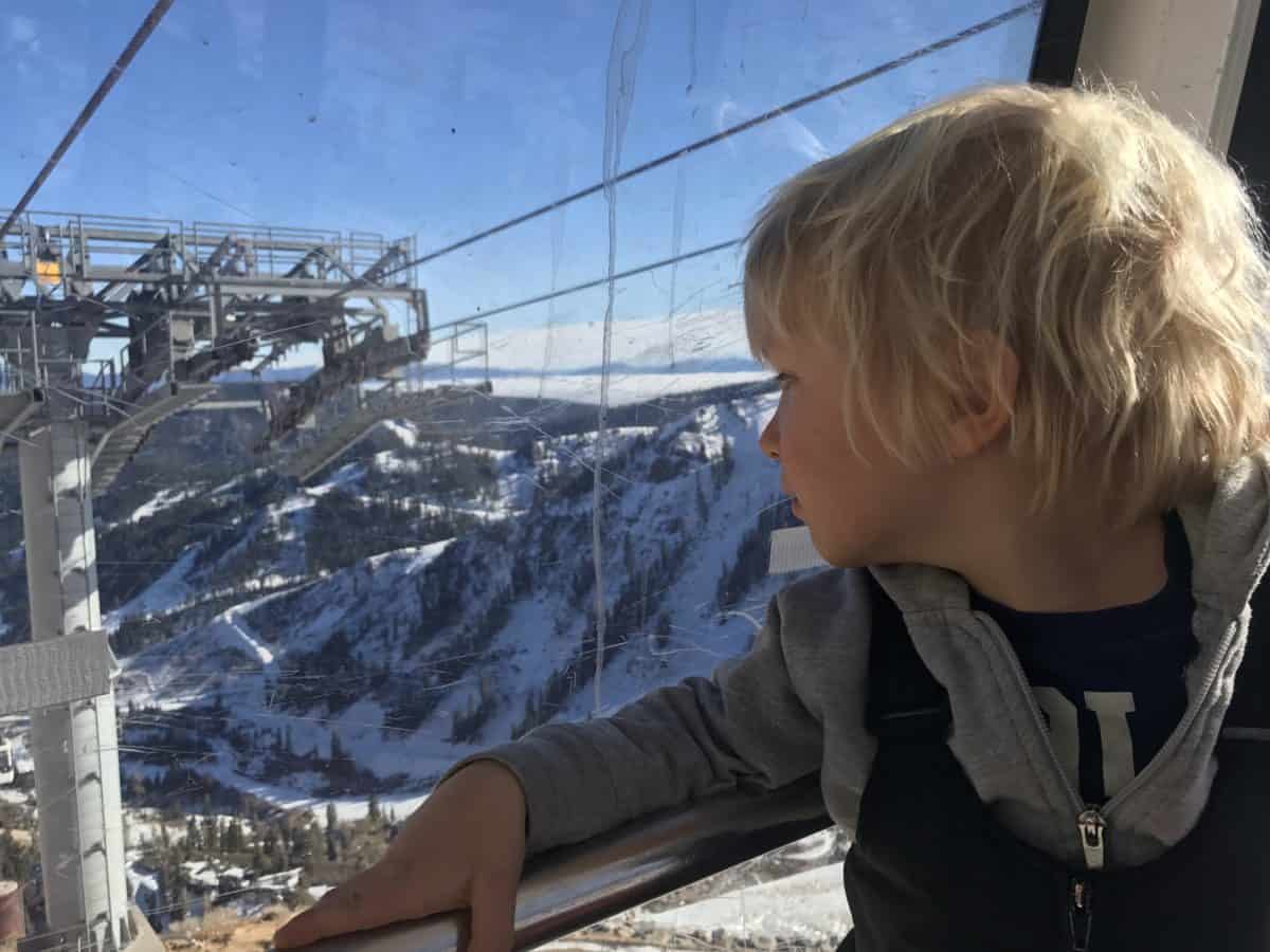 pre-k student looking out a ski lift
