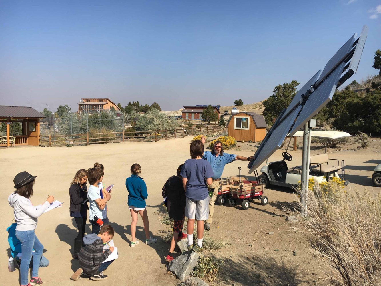 students looking up at solar panels