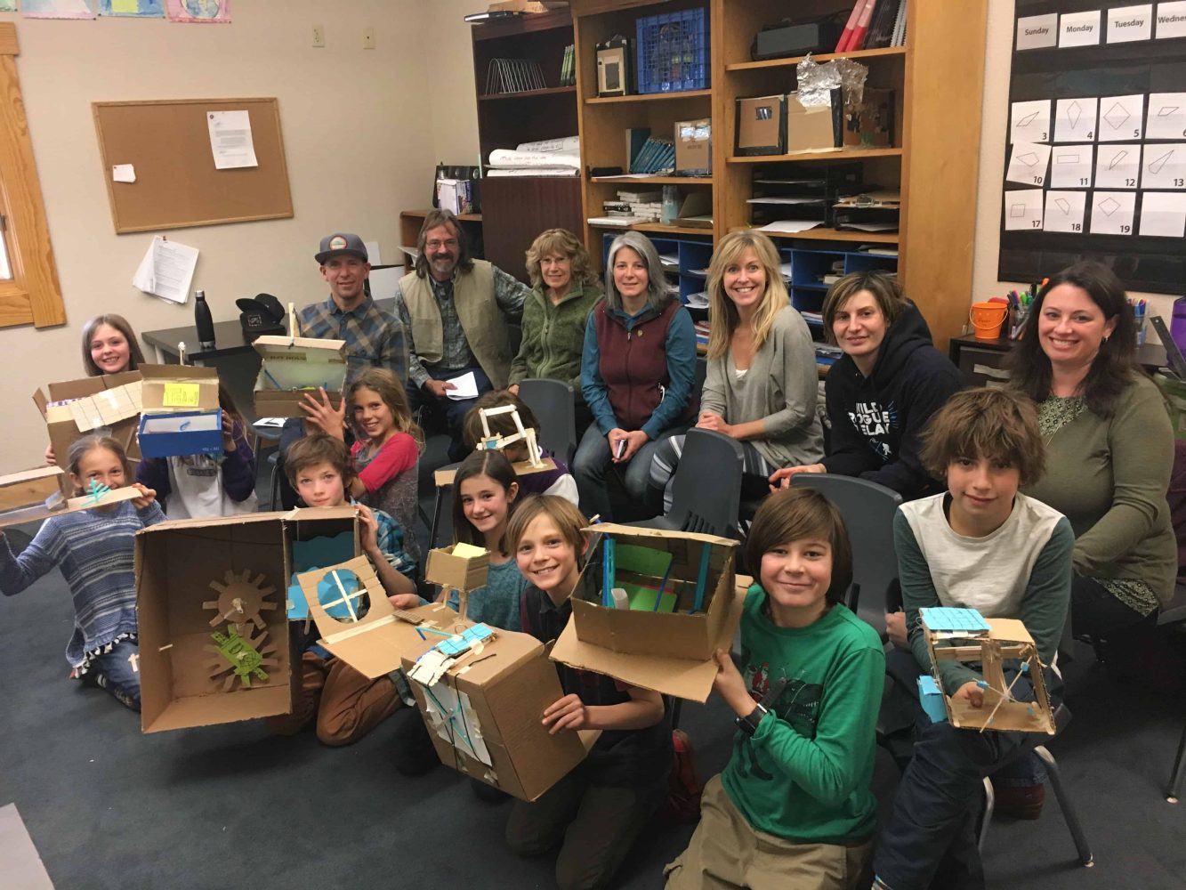 students hilding their cardboard green energy prototypes