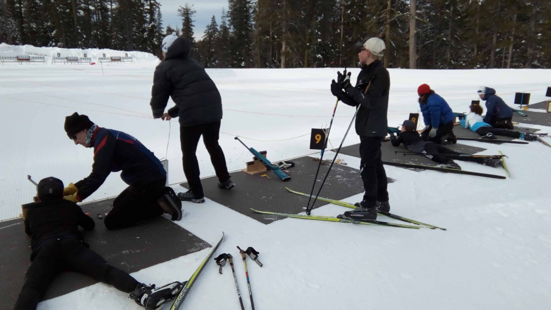 biathletes practicing at a shooting range