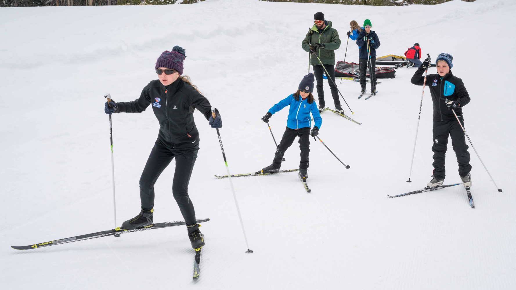 students skiing down a slope