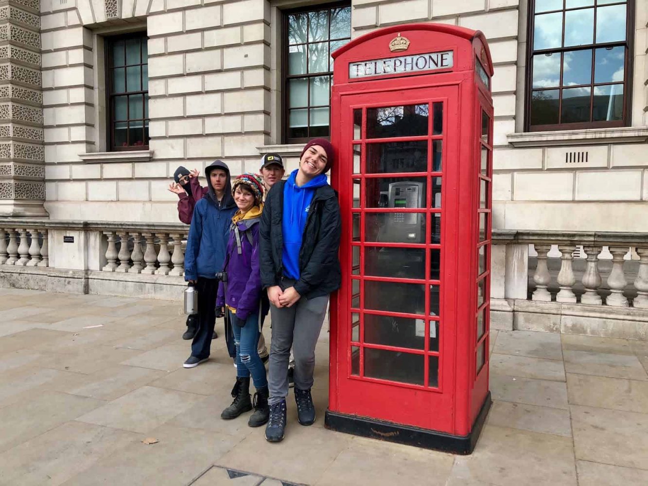 students next to an old telephone booth