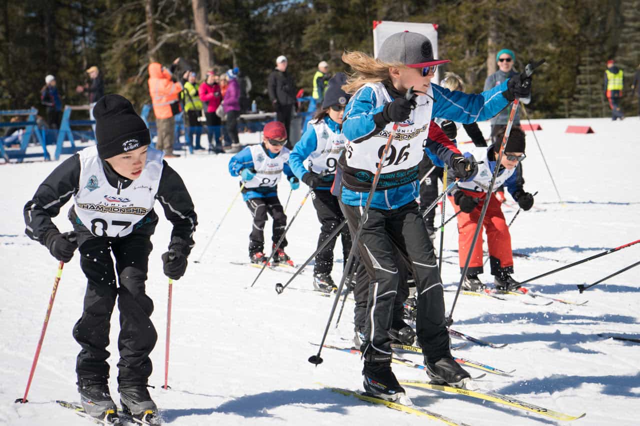 students racing downa ski course