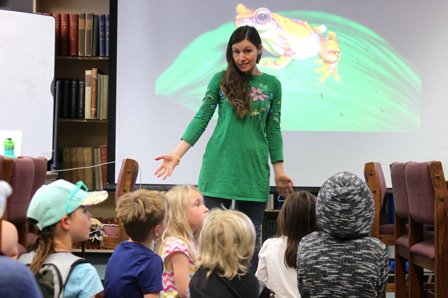 teacher speaking to kindergarteners sitting