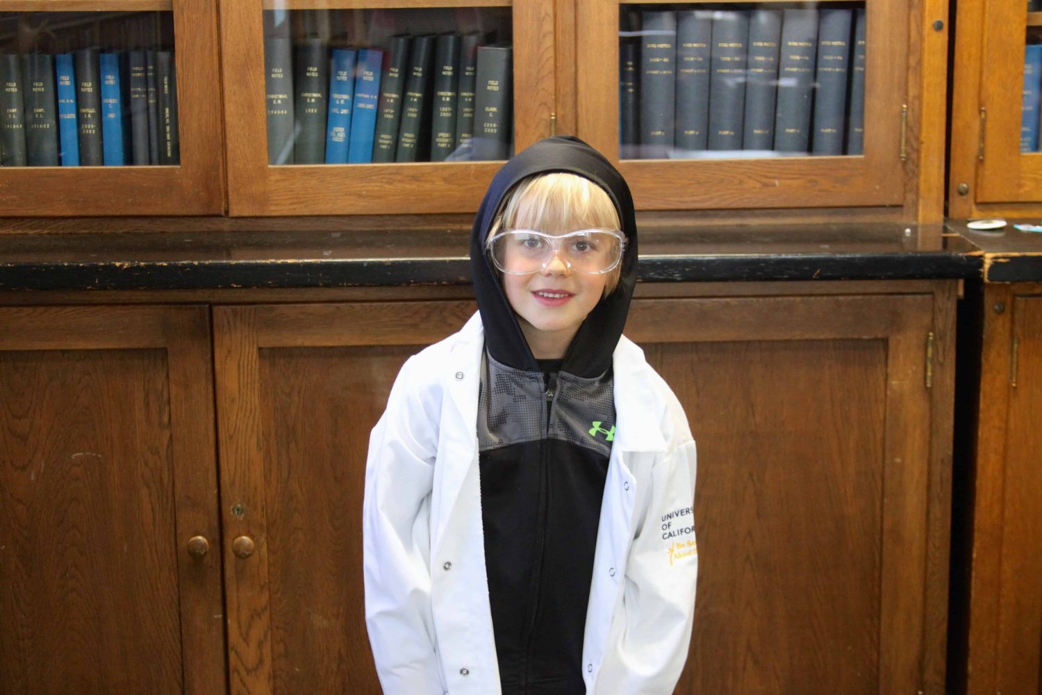 kindergartener with lab coat smiling