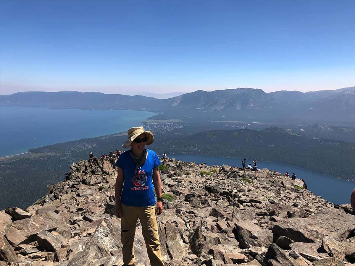 a member of the backpacking crew on a cliff