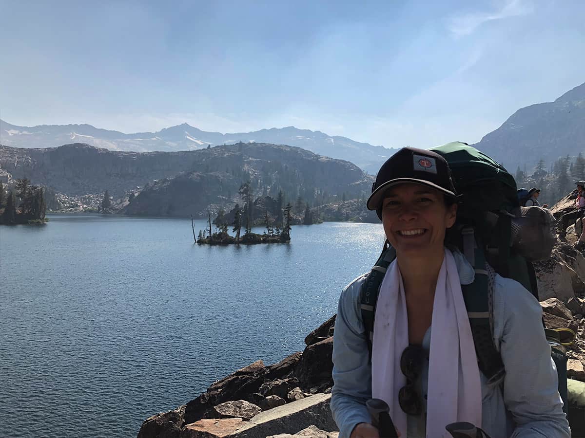 a backpacking crew member smiling for the camera