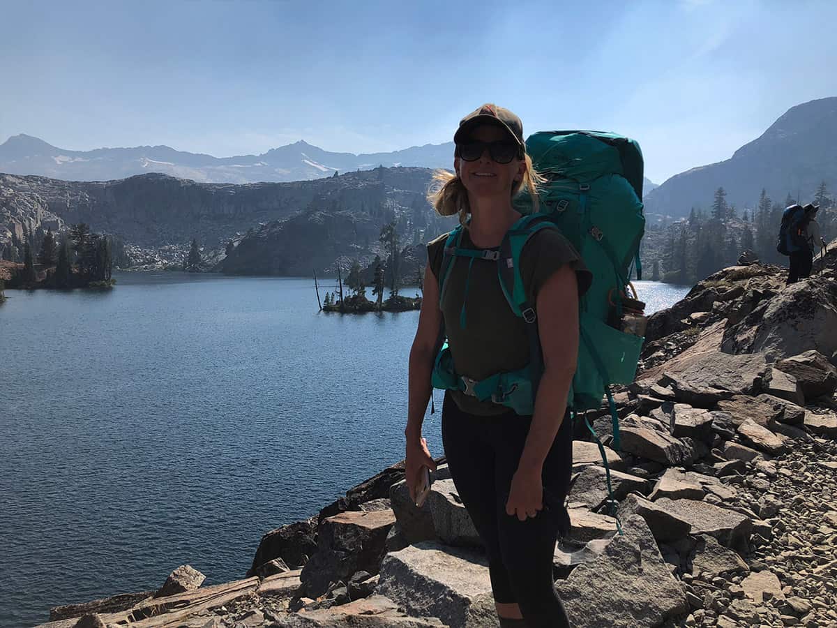 a backpacking crew member smiling for the camera