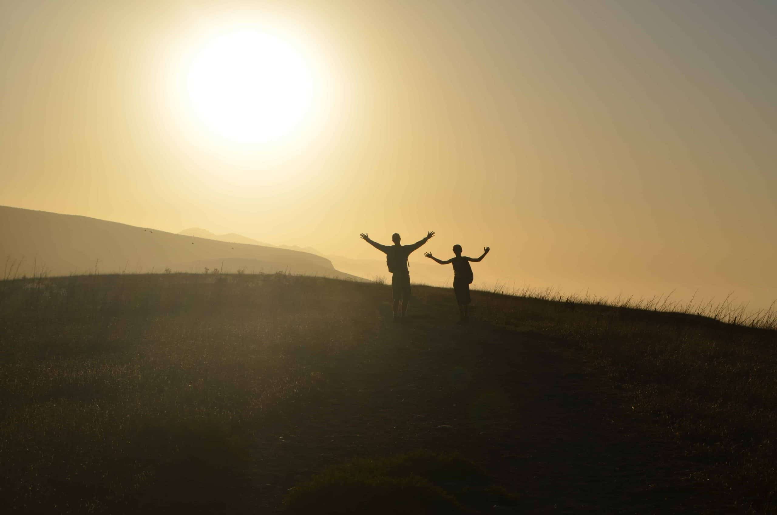 two students greeting the rising sun