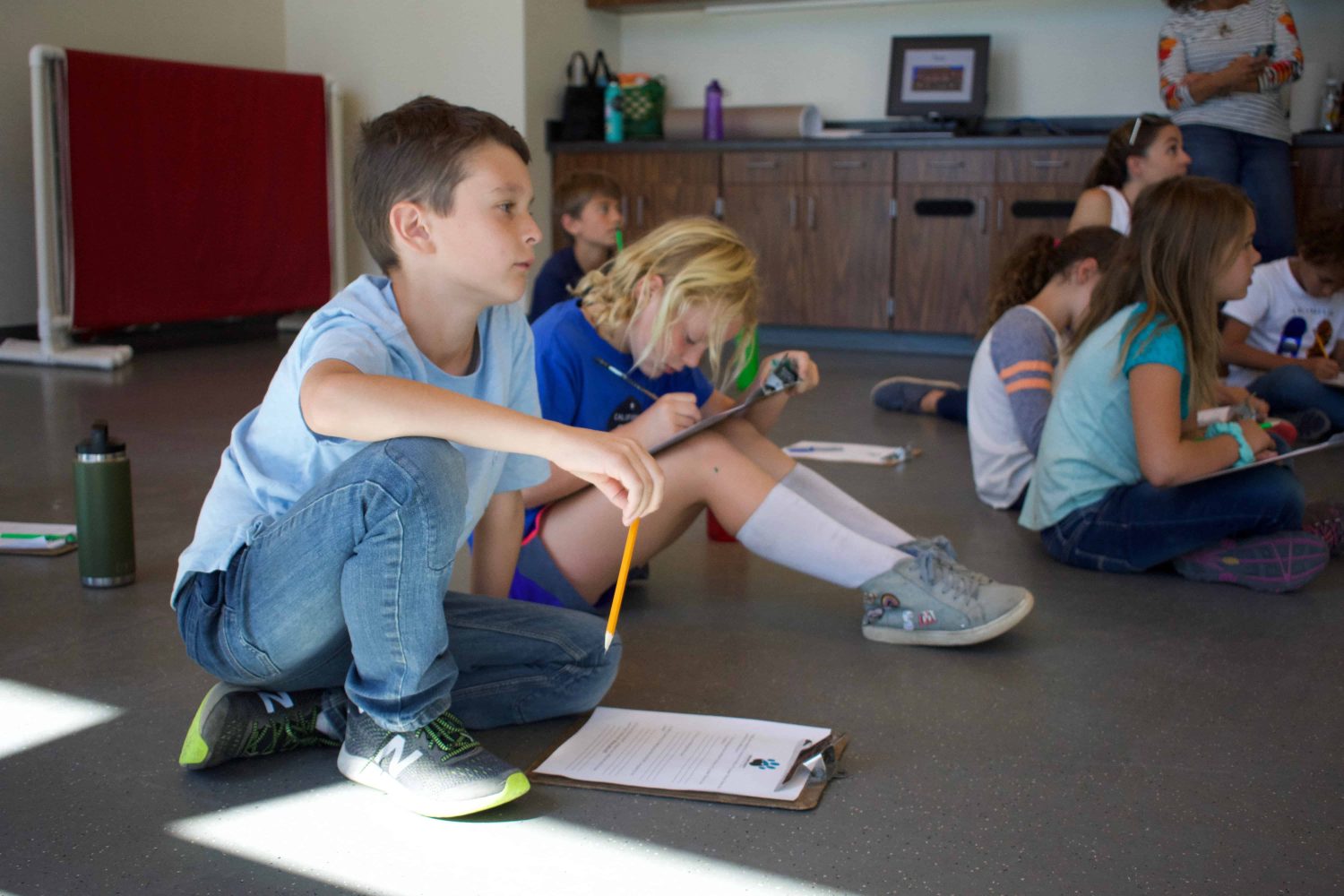 students with clipboards sitting while studying