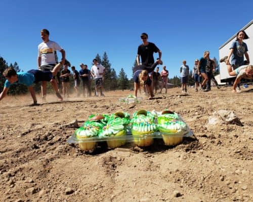 students doing a wheelbarrow race