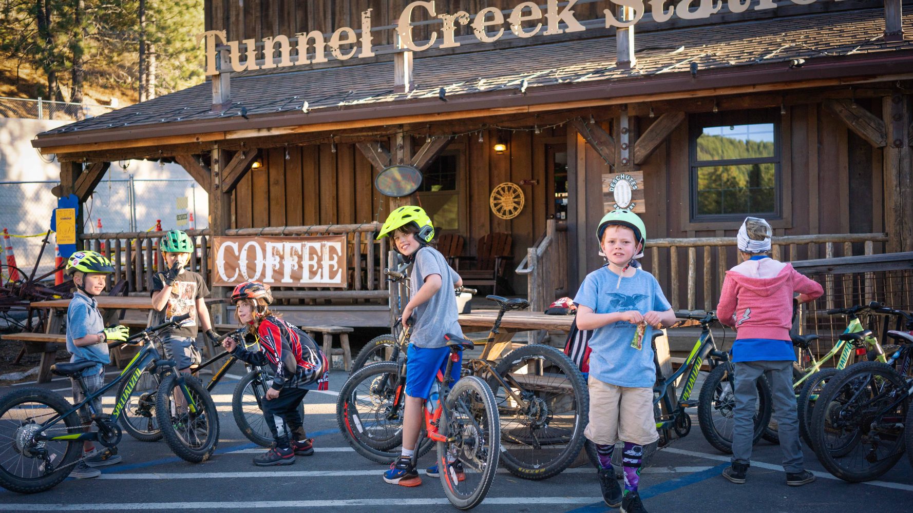 kids with their bikes in front of tunnel creek store