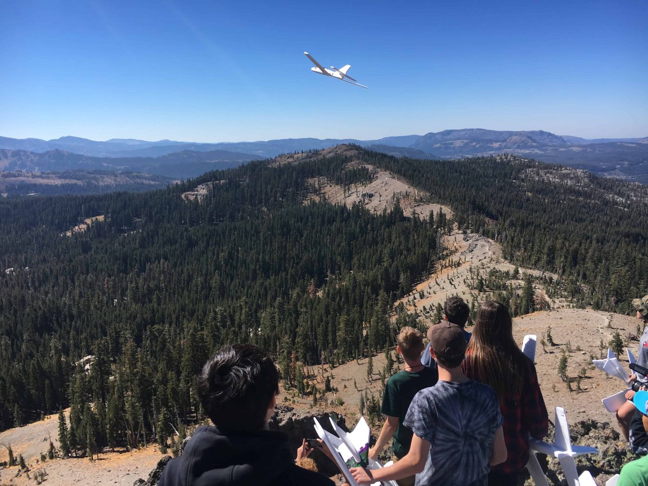 students launch gliders near castle peak