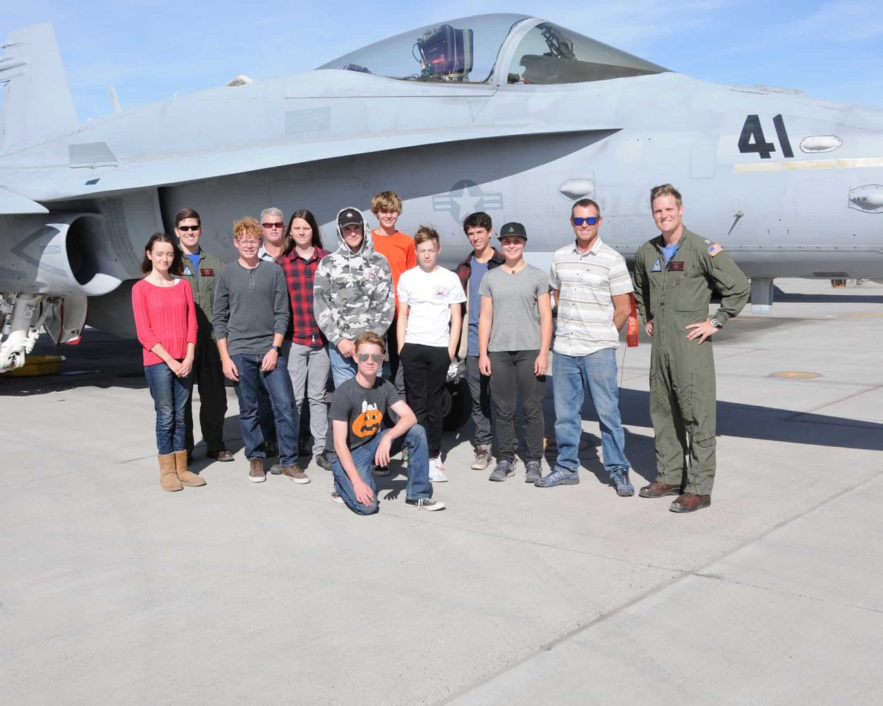 students in front of an f-18 jet