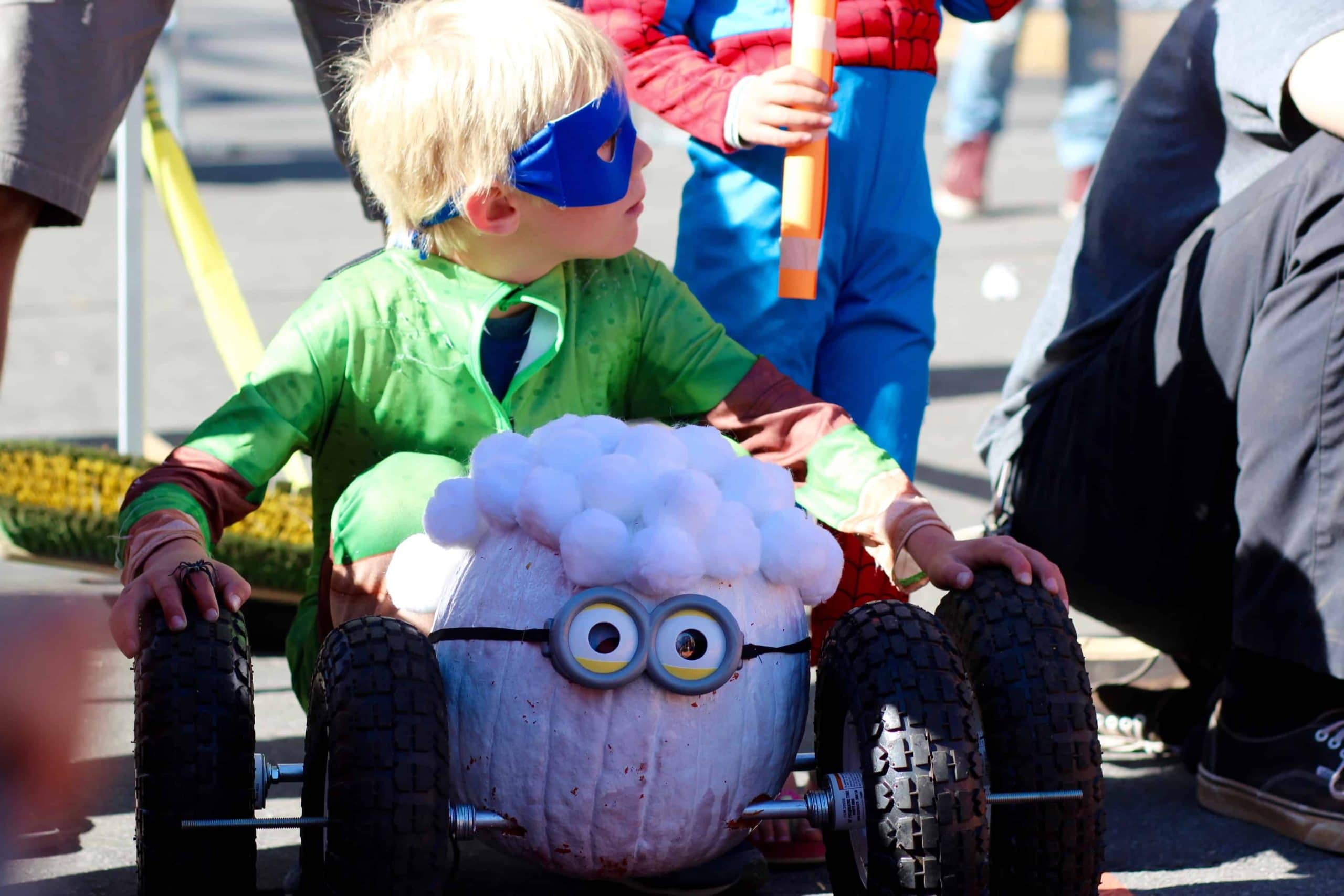 a student readies his pumpkin racer