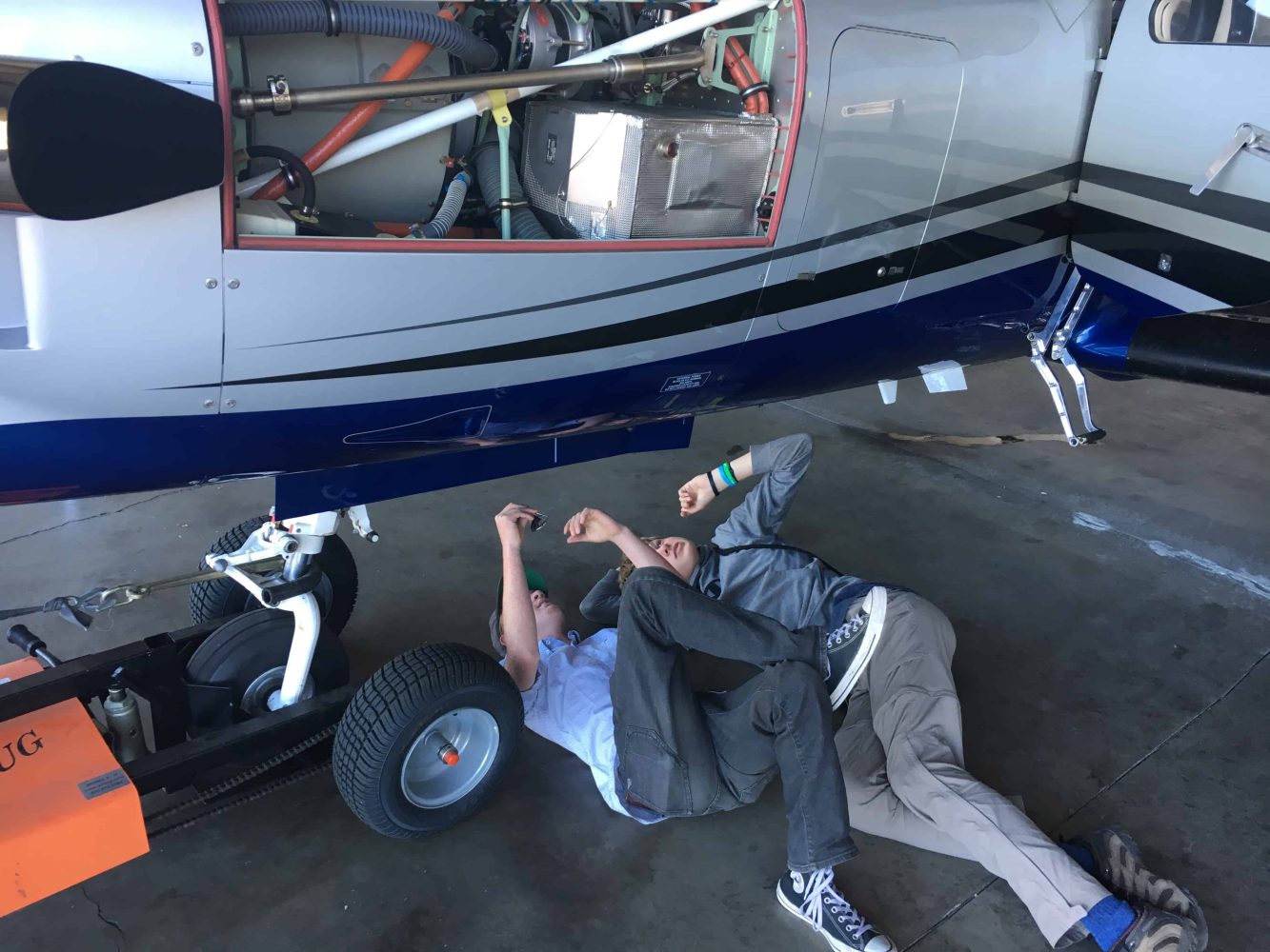 student inspecting the belly of a plane