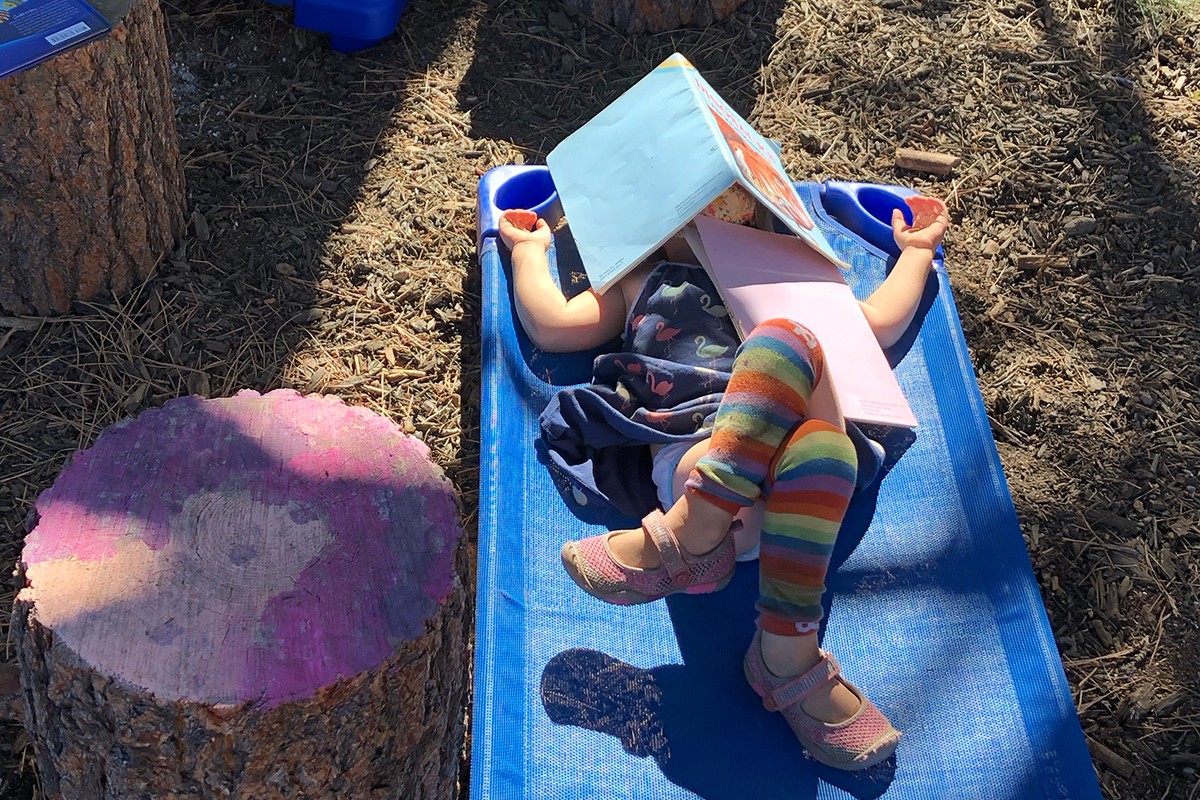 A Pre-K student sleeping on a cot