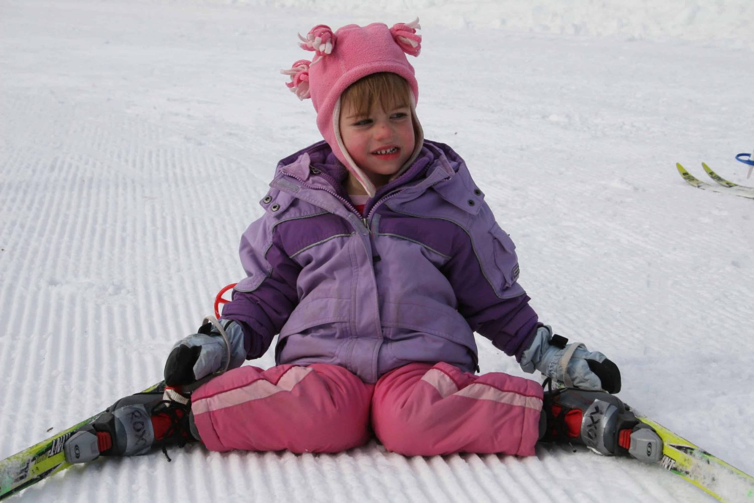 pre-k student sitting in the snow
