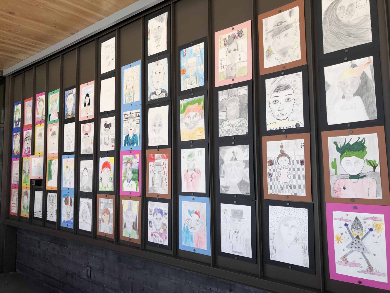 elementary students art along a wall