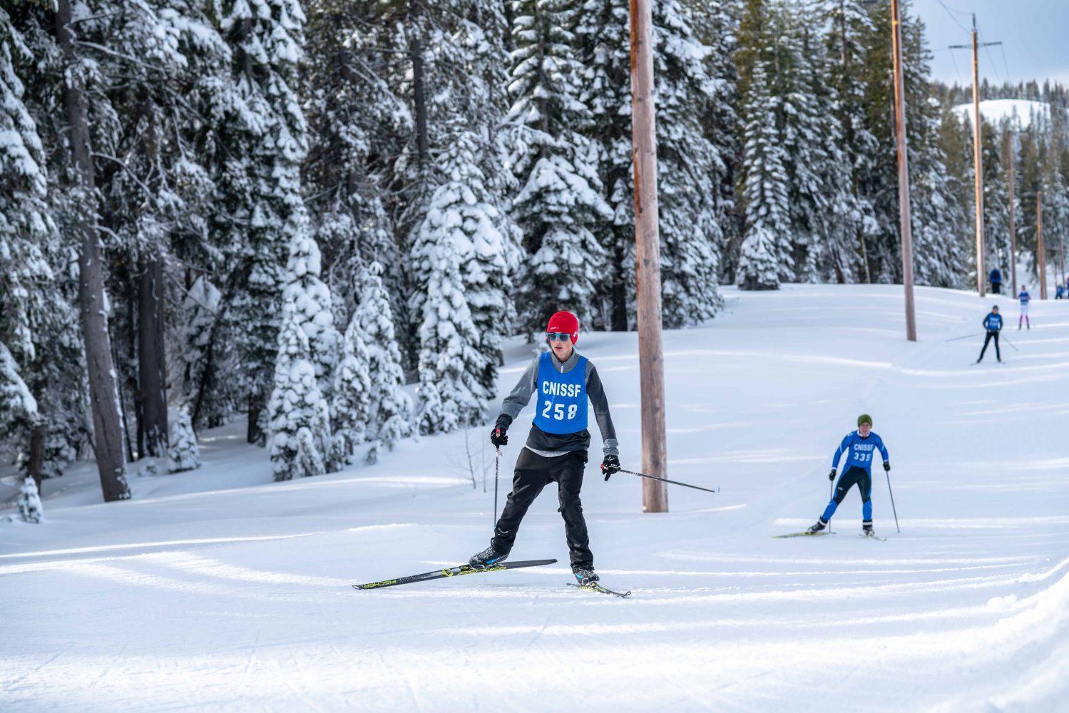 nordic race participants skiing down the track
