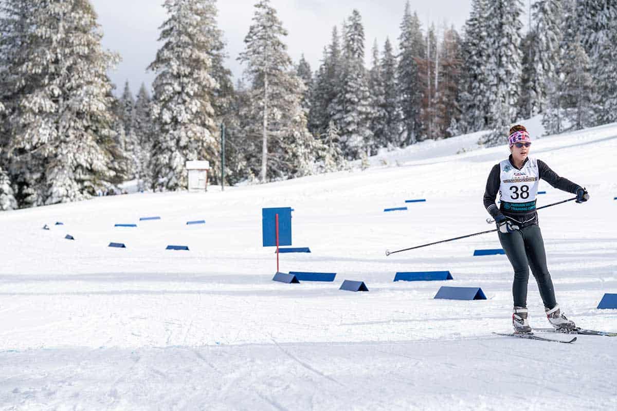 a biathlete student racing down the snowy track