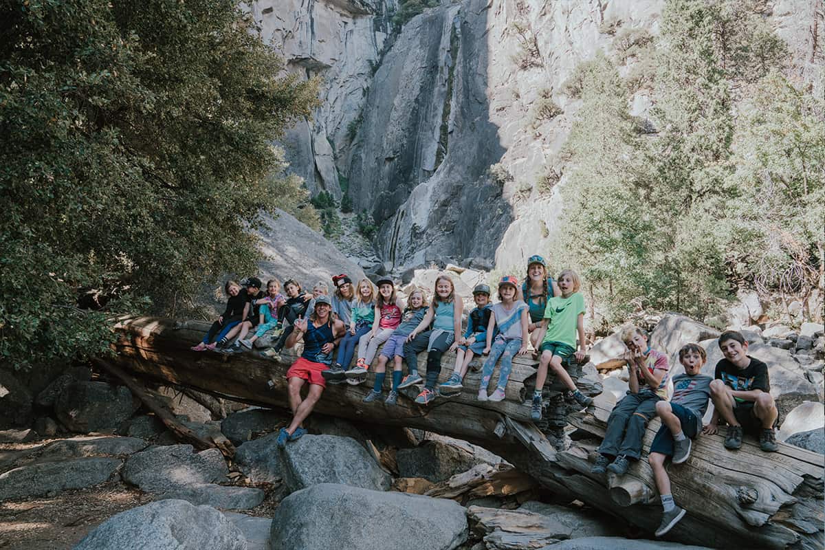 4th grade class sitting on a long log