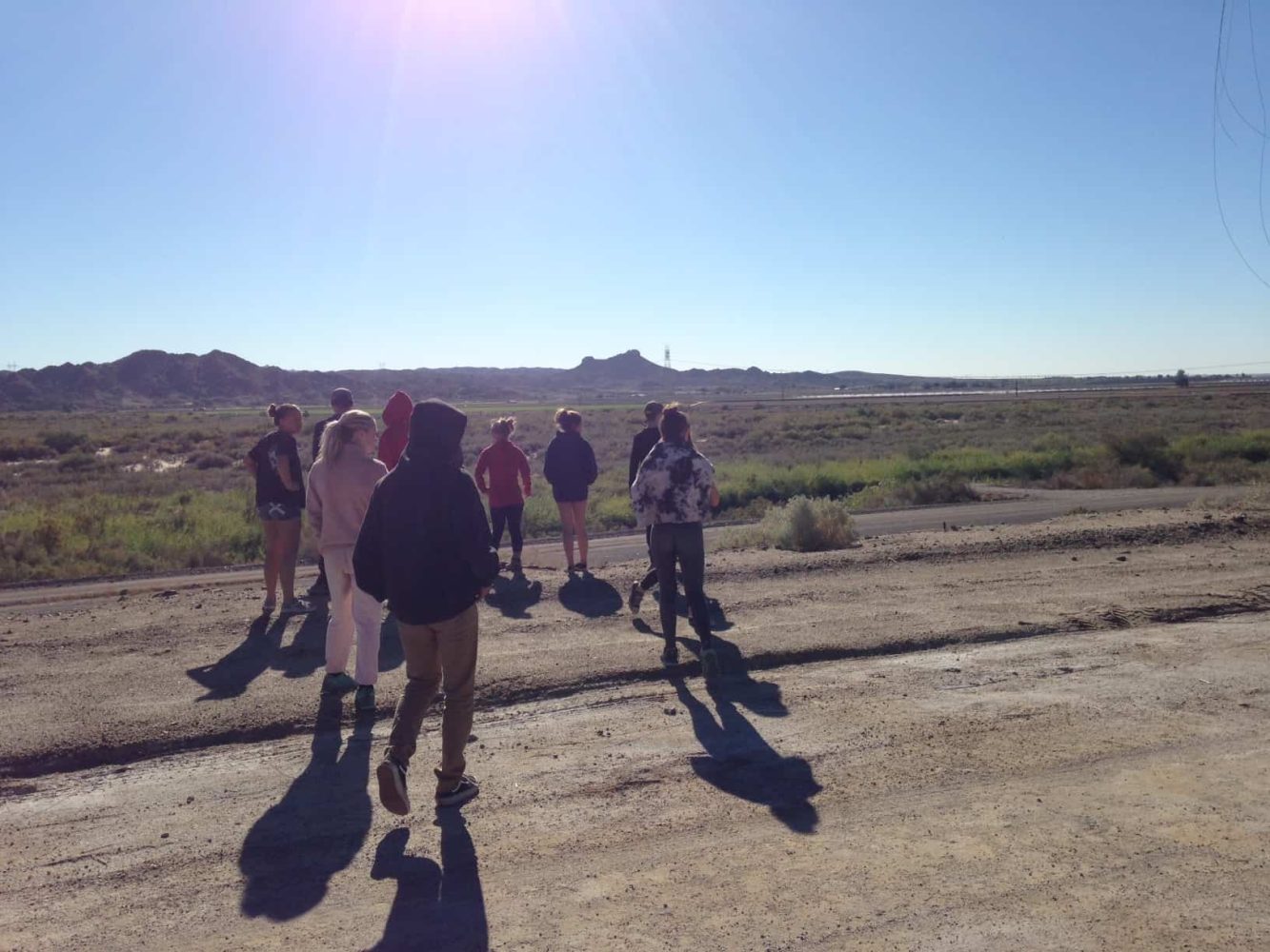 students walking along a dirt road