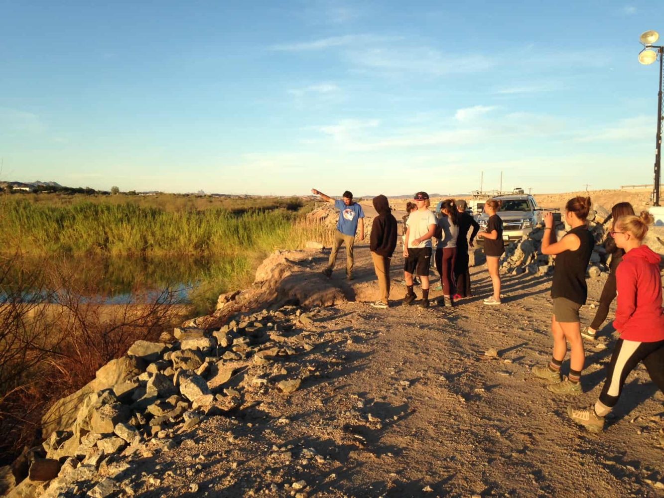 students standing next to the colorado river