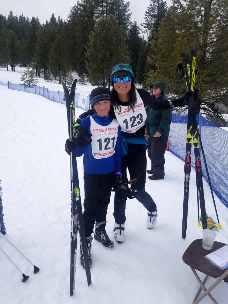 kids holding their skis have their picture taken