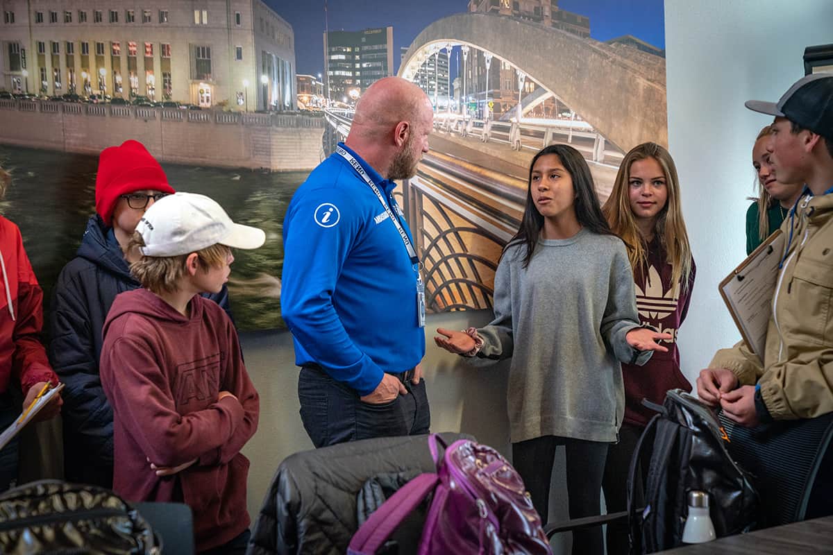 a girl talking to a community leader