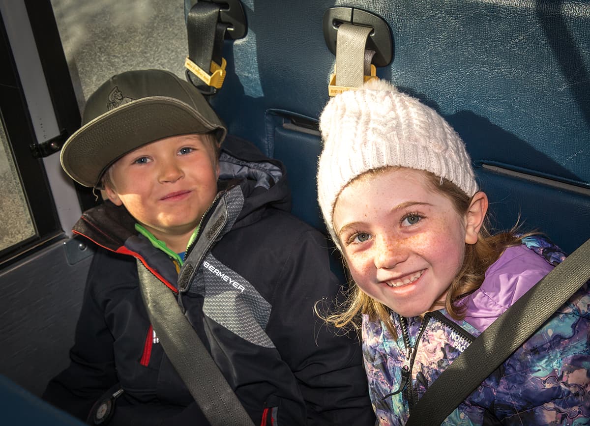 students with their seatbelts on in a car