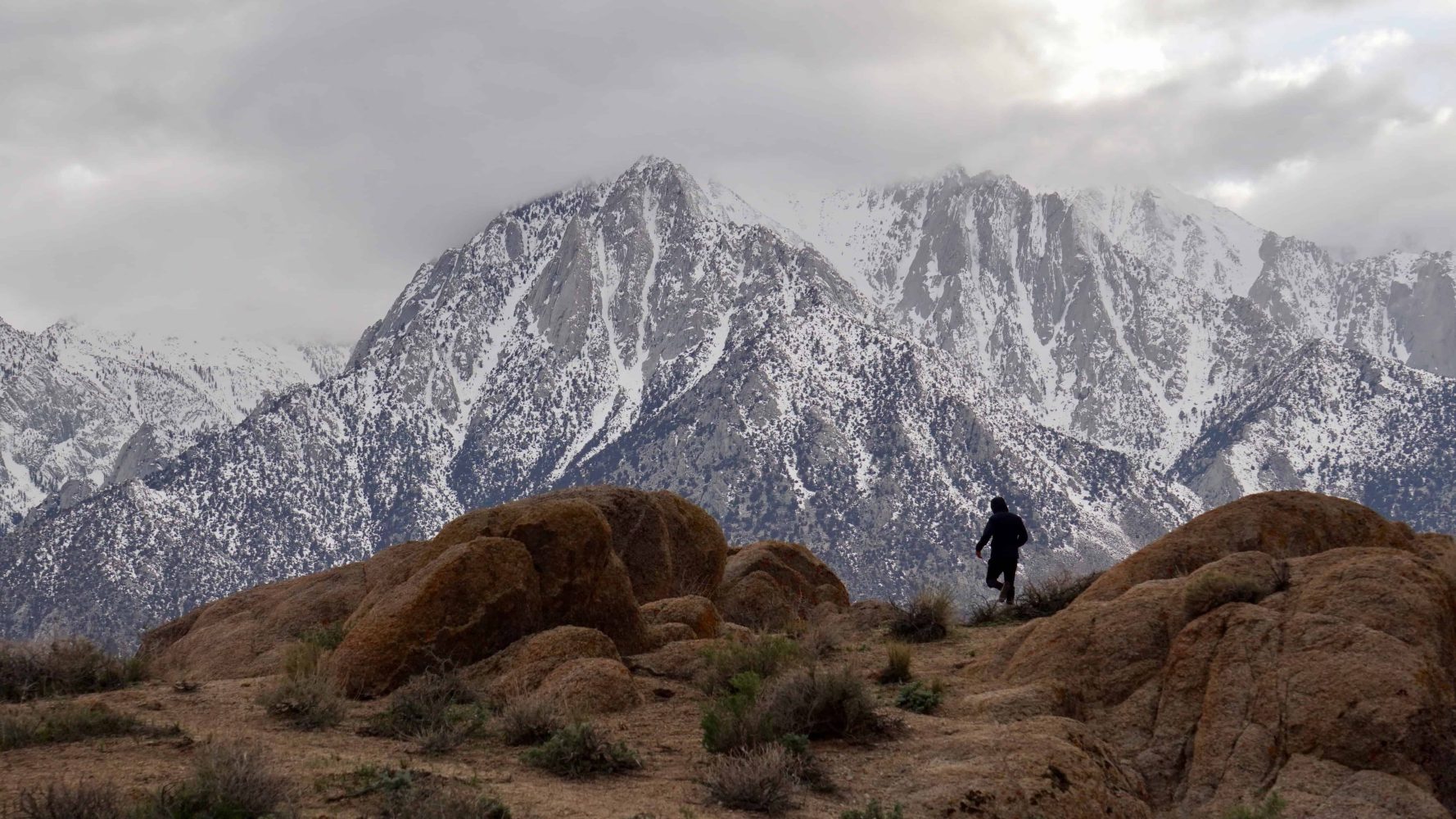a student trekking through the alabama hills